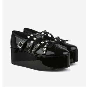 Comme des garcons Noir by patent black wedge with silver studs. Runway looks